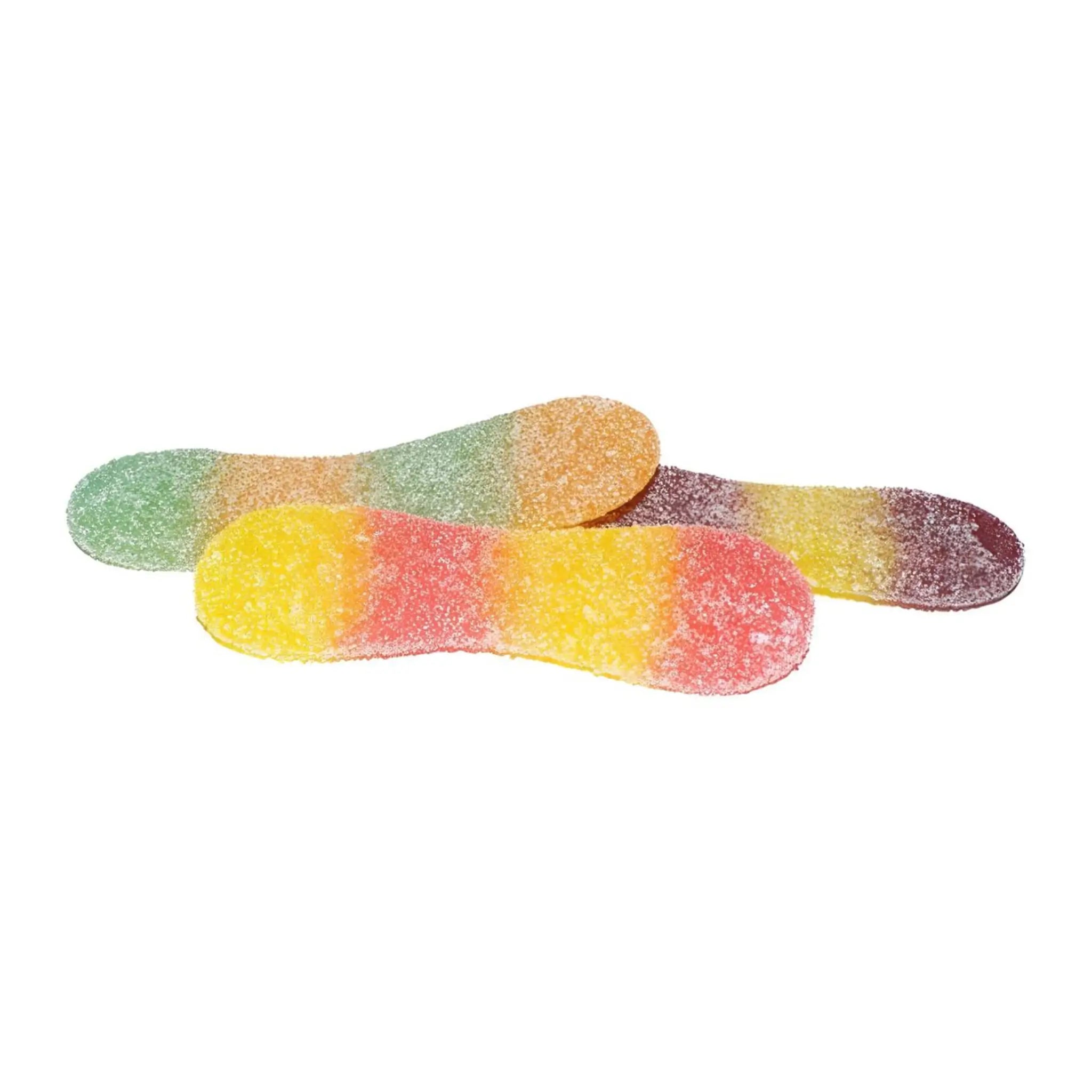 Three pieces of Swedish candy shaped like tongues and coated in sugar, in orange and green, purple and yellow, and yellow and red.