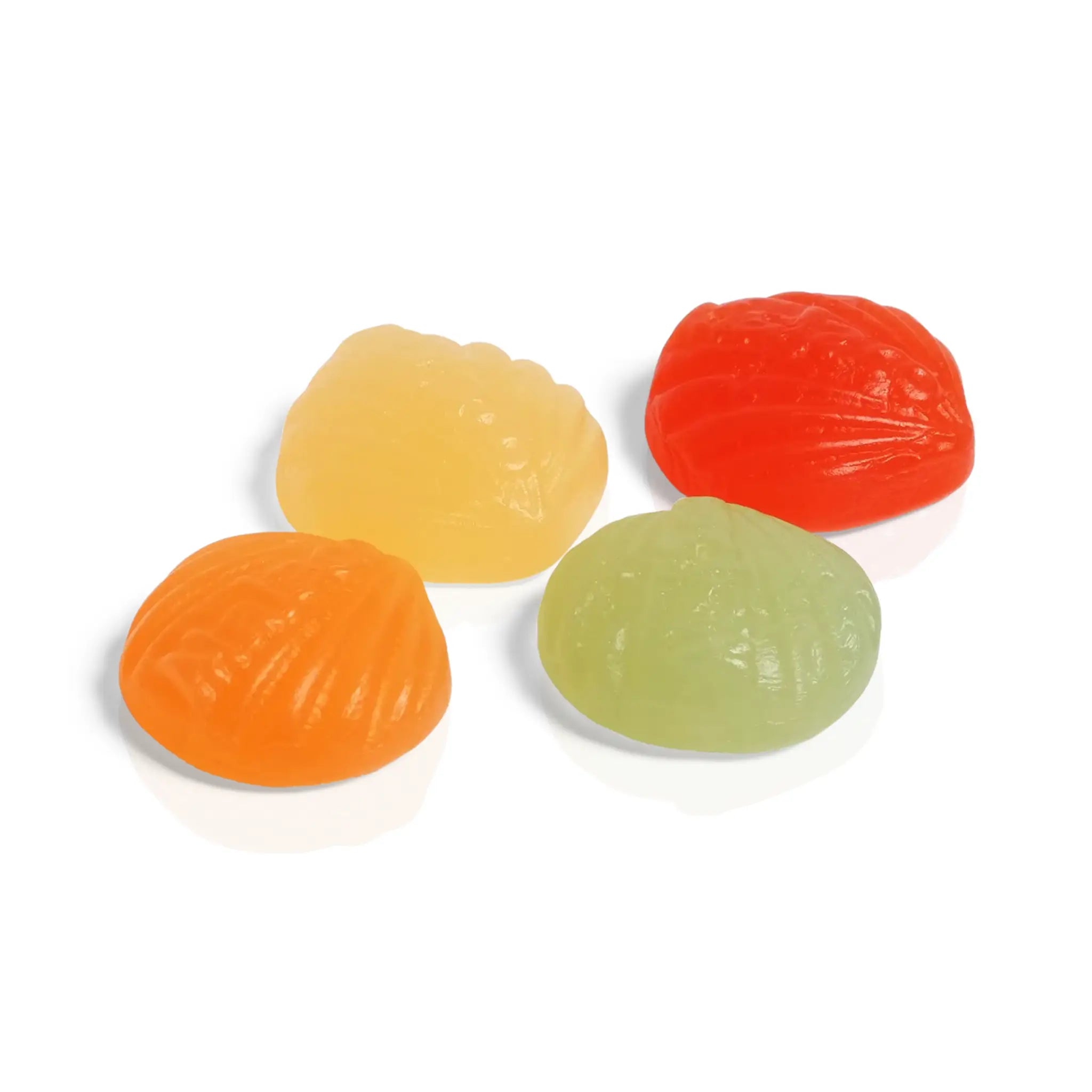 Four pieces of Swedish candy in green, yellow, red and orange, shaped like shells.