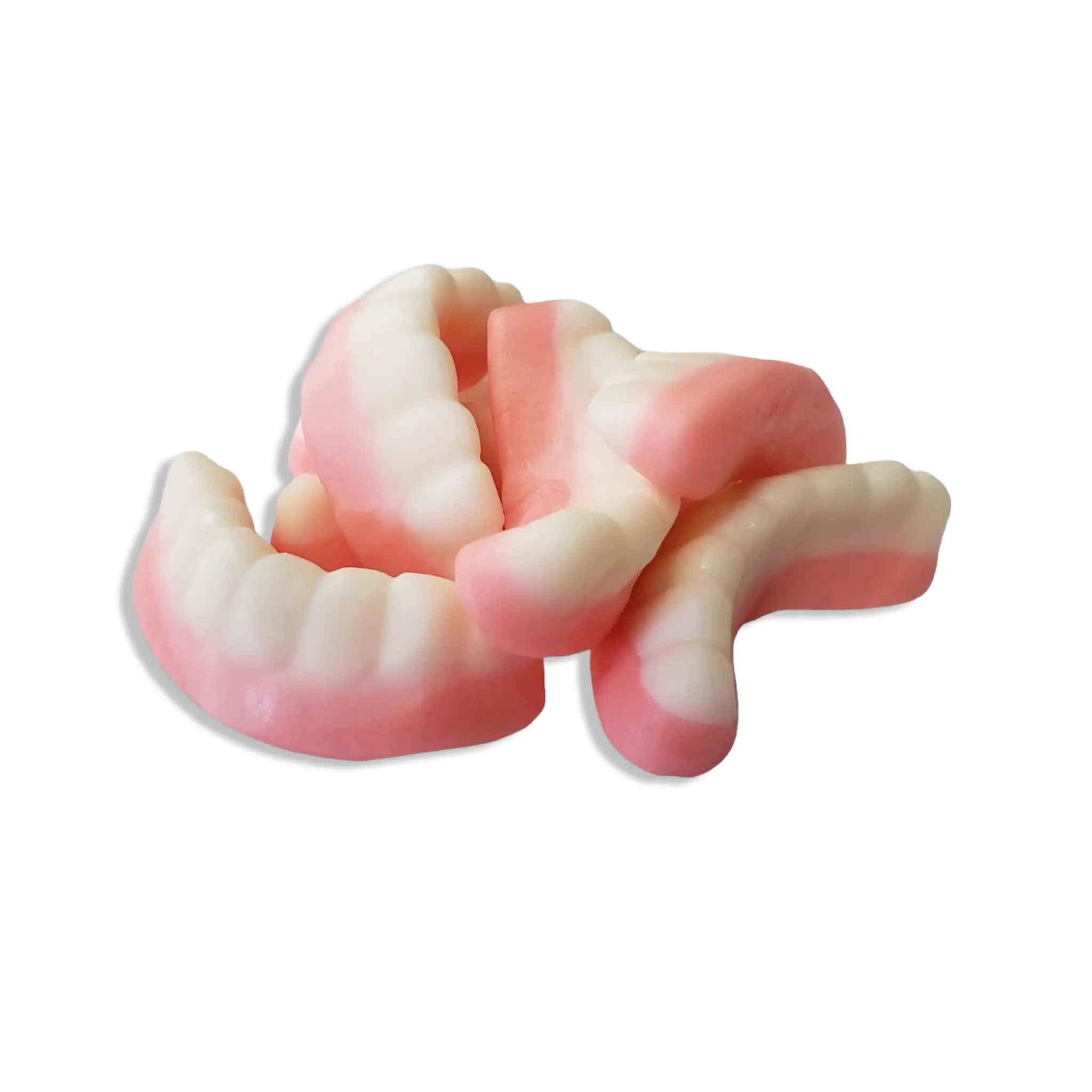 Swedish candy shaped like loose teeth in white and pink.
