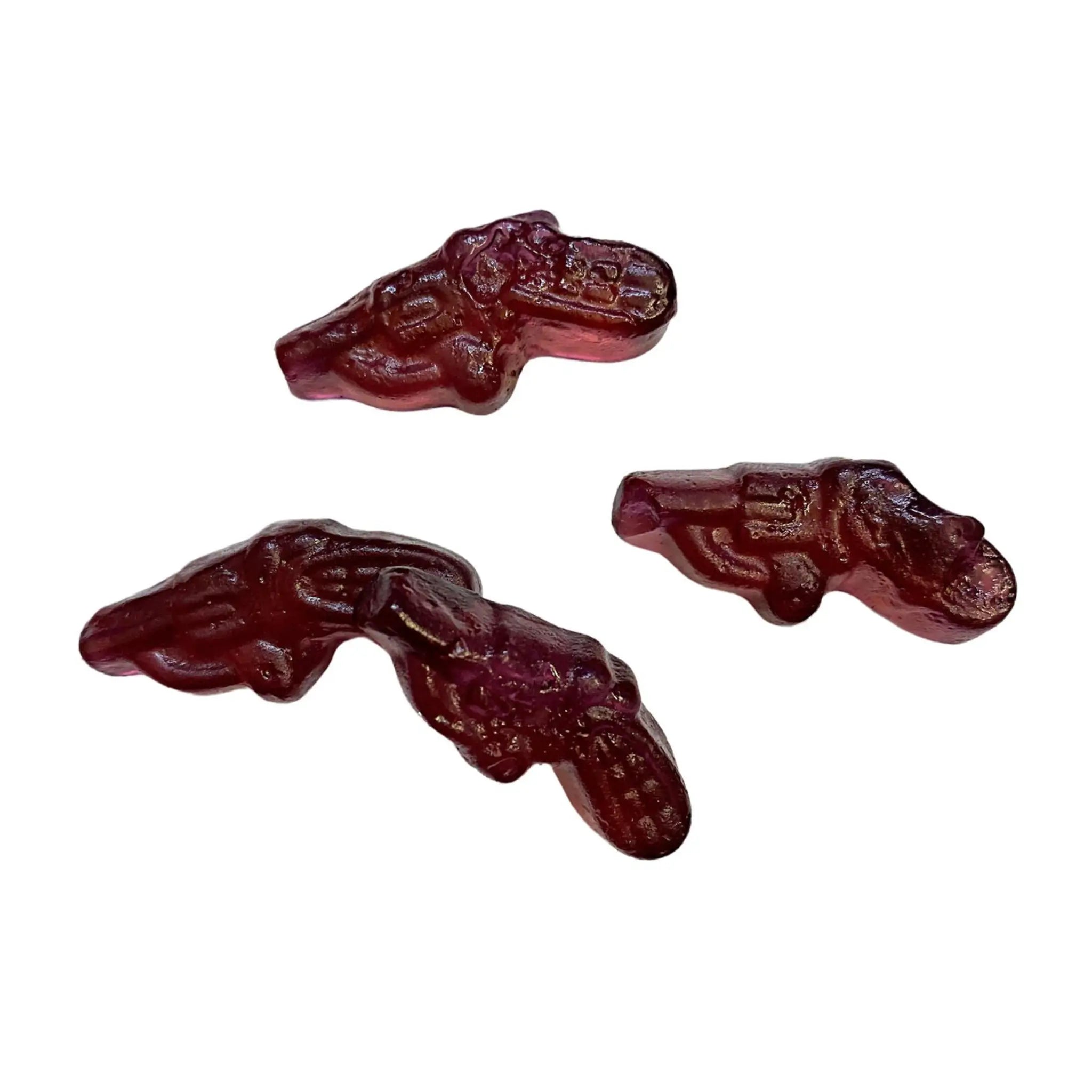 Four pieces of Swedish candy in violet, shaped like pistols.