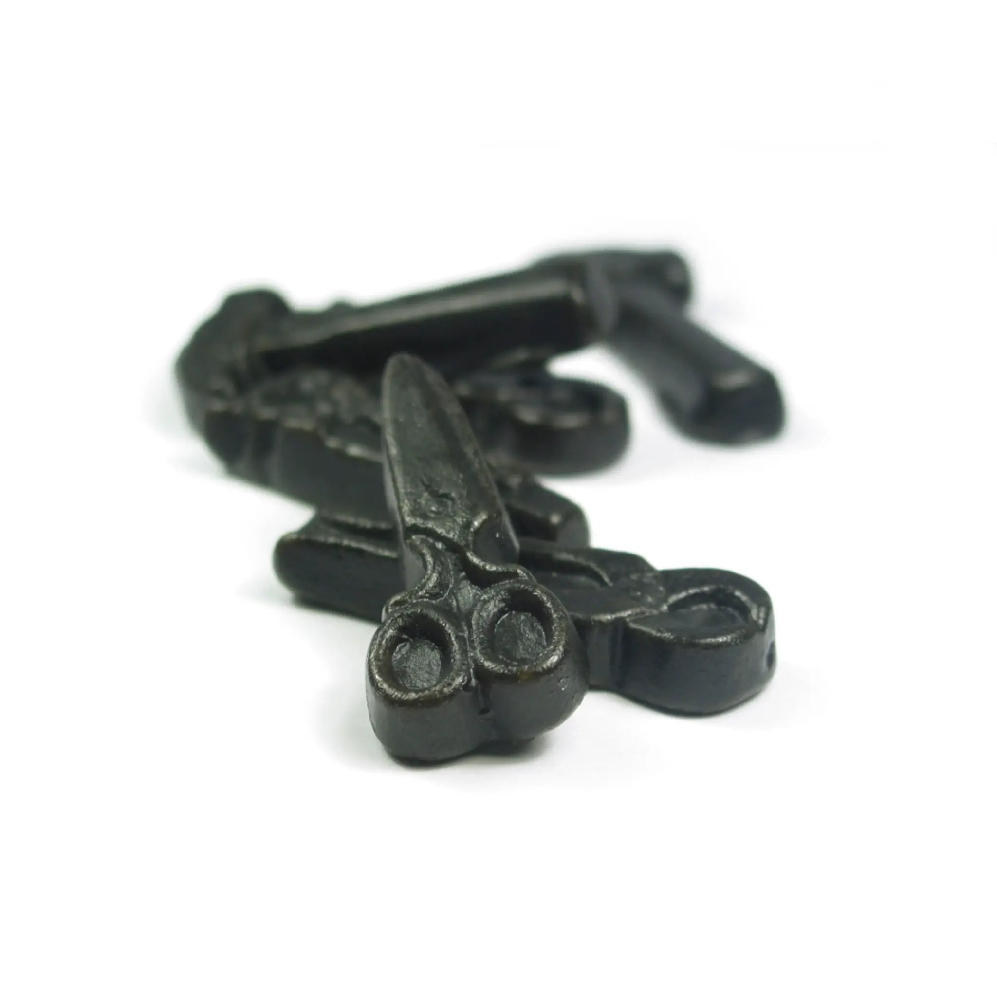 Swedish candy shaped like scissors and other tools, in black.