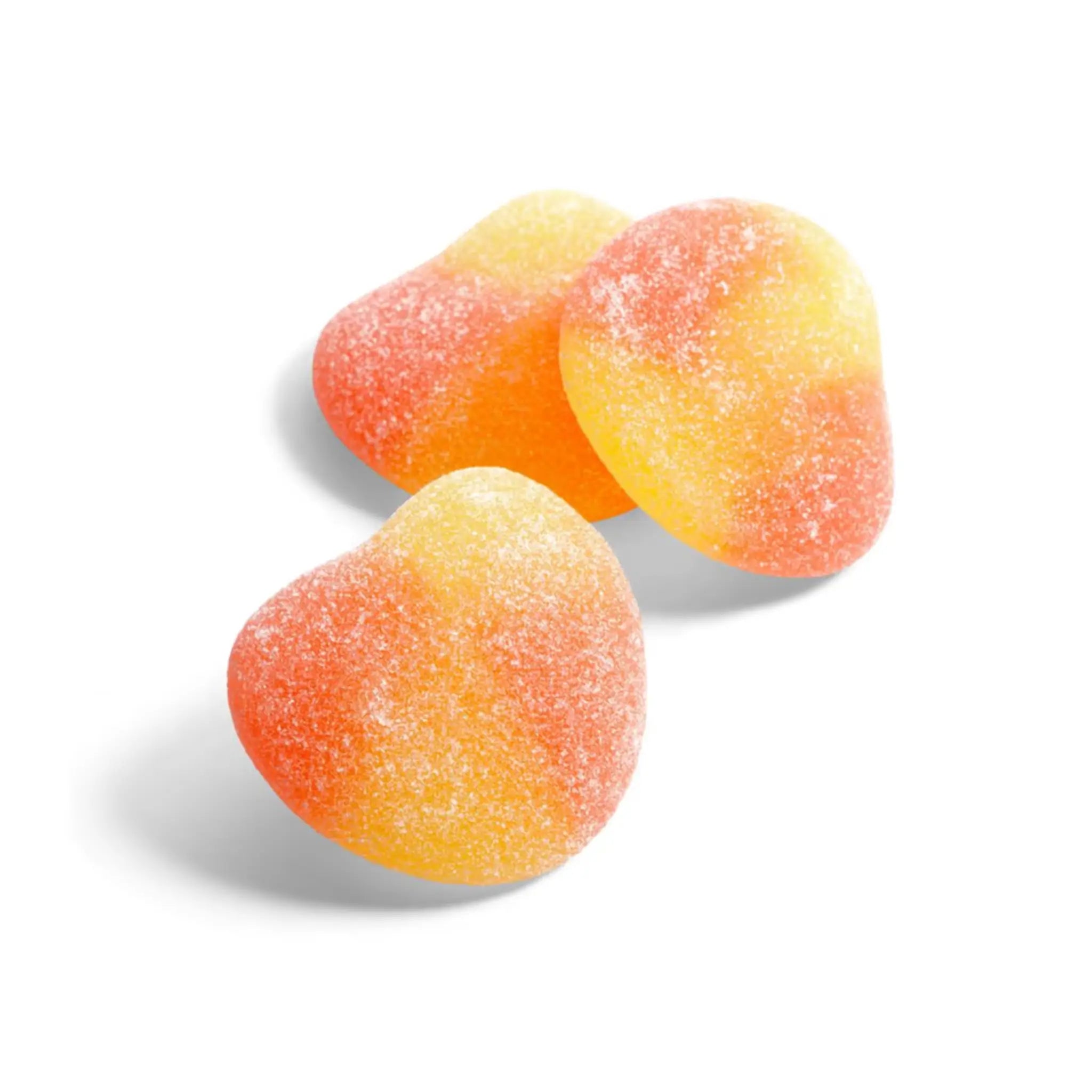 Three pieces of Swedish candy in the shape of peaches in orange and yellow, coated in sugar.