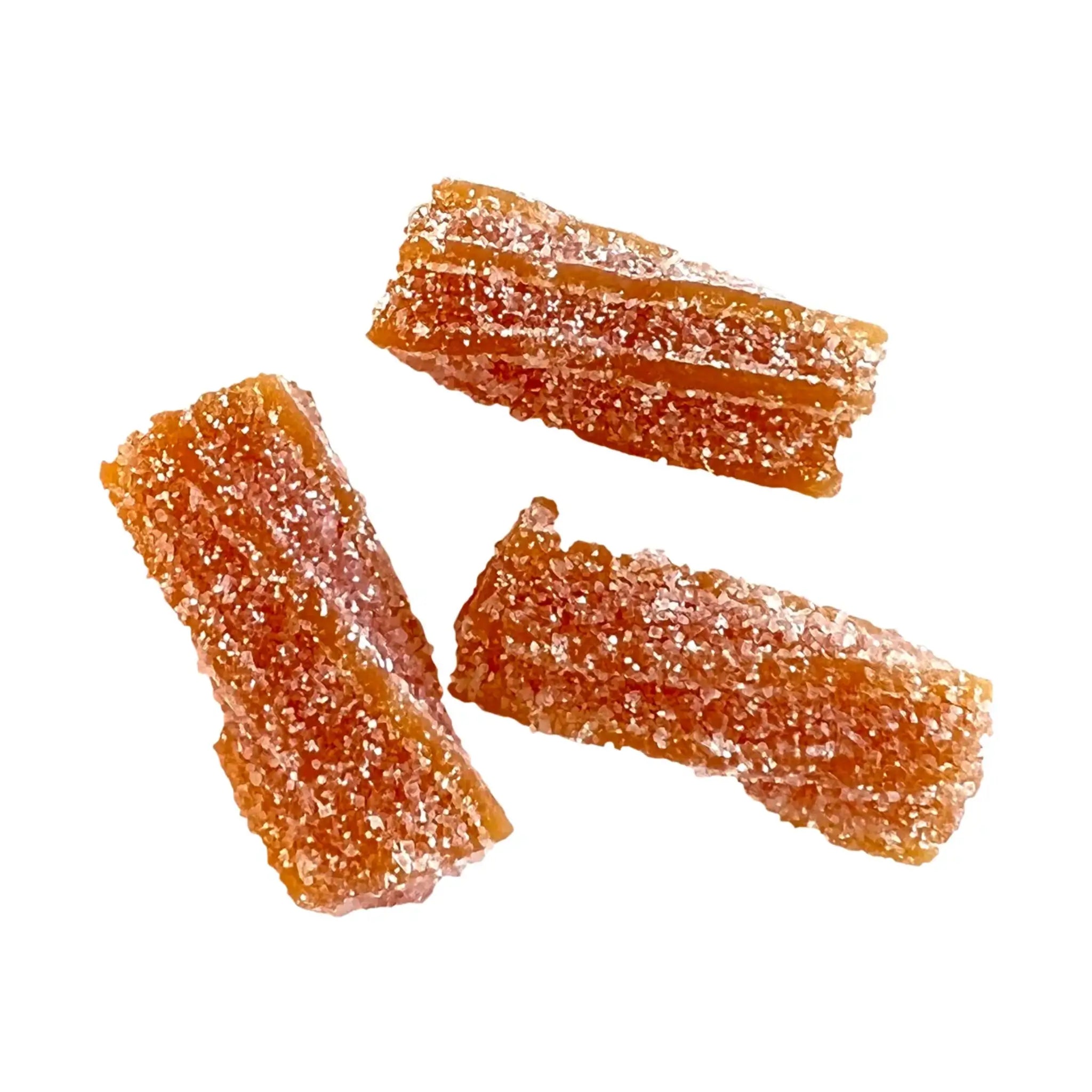 Three pieces of Swedish candy, twisted, orange and coated in sugar.