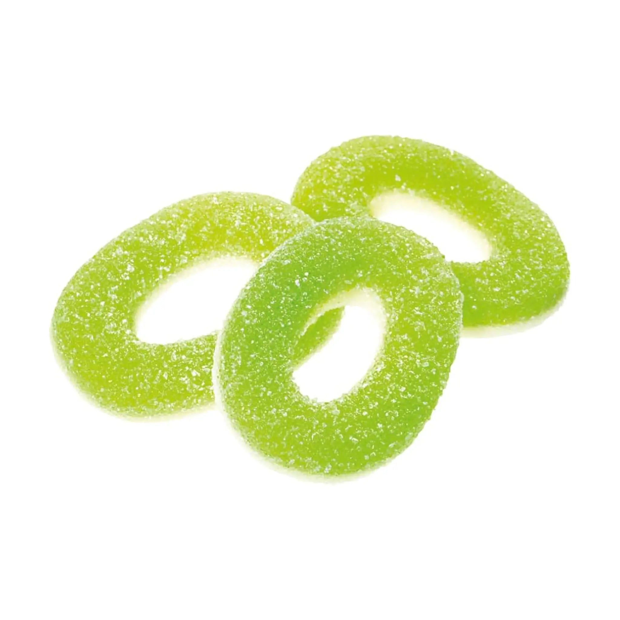 Three pieces of Swedish candy in the shape of green rings, coated in sugar.