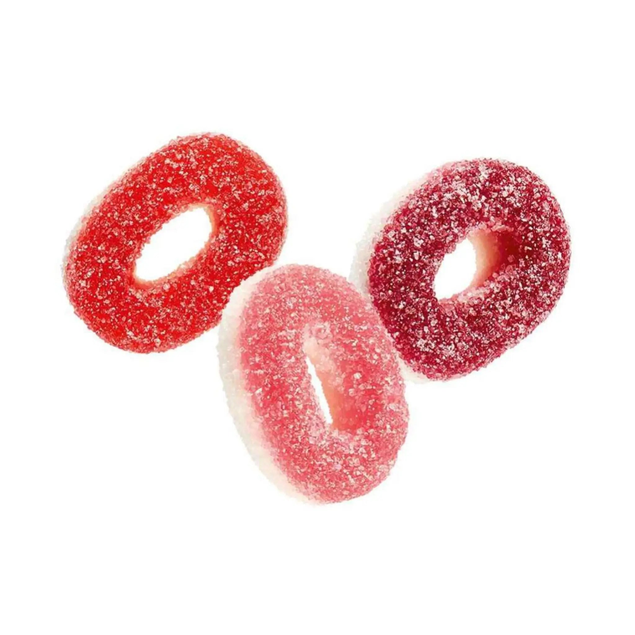 Three pieces of Swedish candy coated in sugar and shaped like red and pink rings.