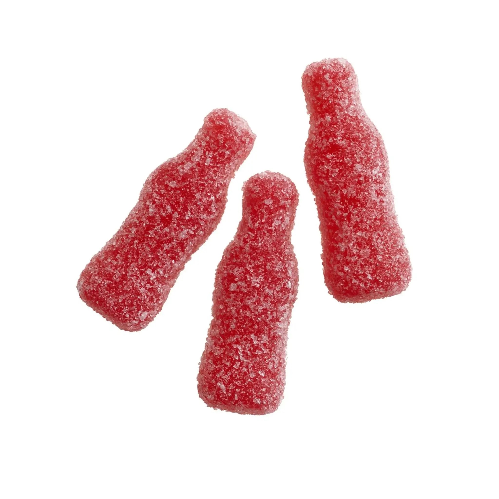 Three pieces of Swedish candy in the shape of red bottles, coated in sugar.