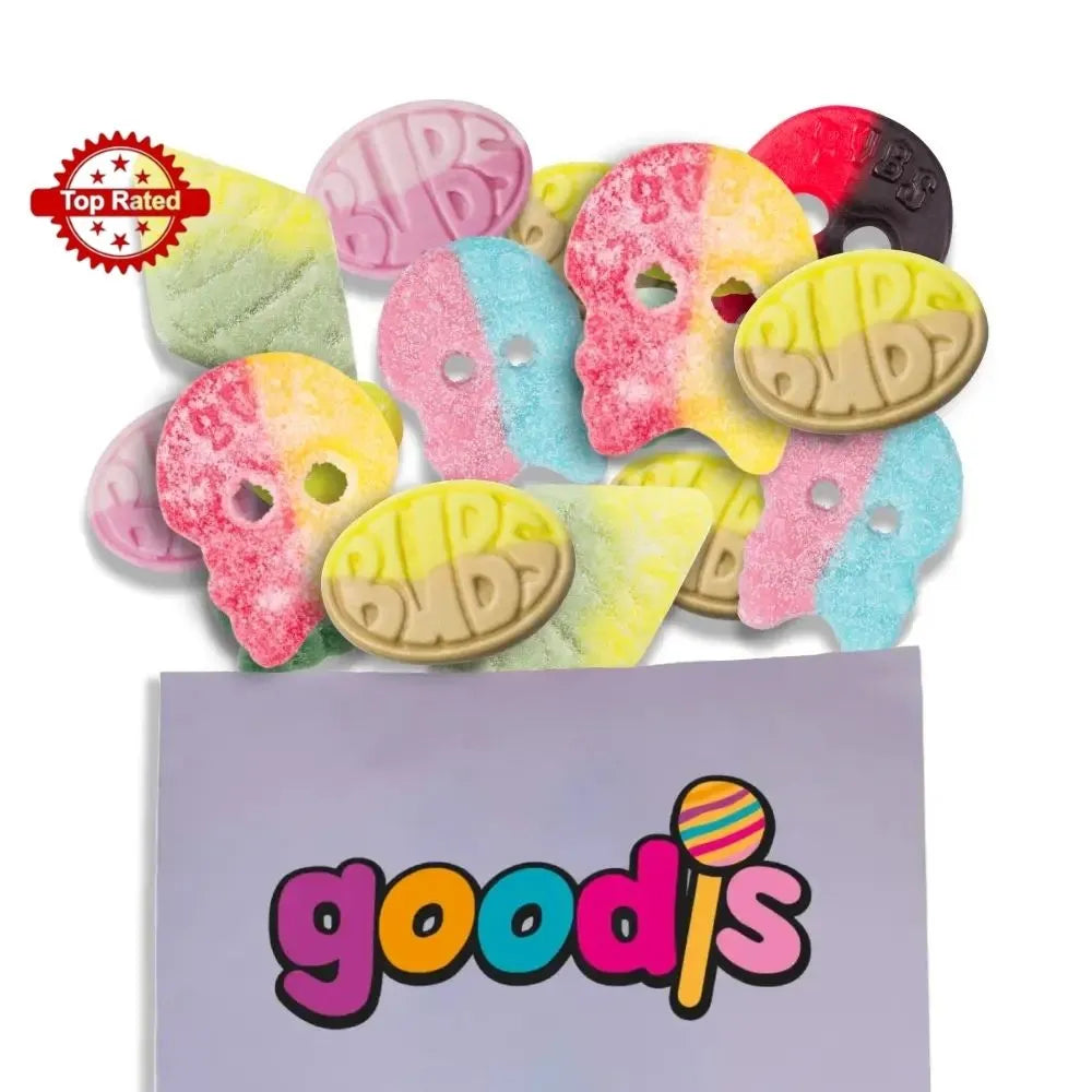 A mix of Swedish candy from the brand "Bubs", in different colors and shapes of skulls, eggs and rhombs, popping out from a purple candy bag with the logo "Goodis" on it.