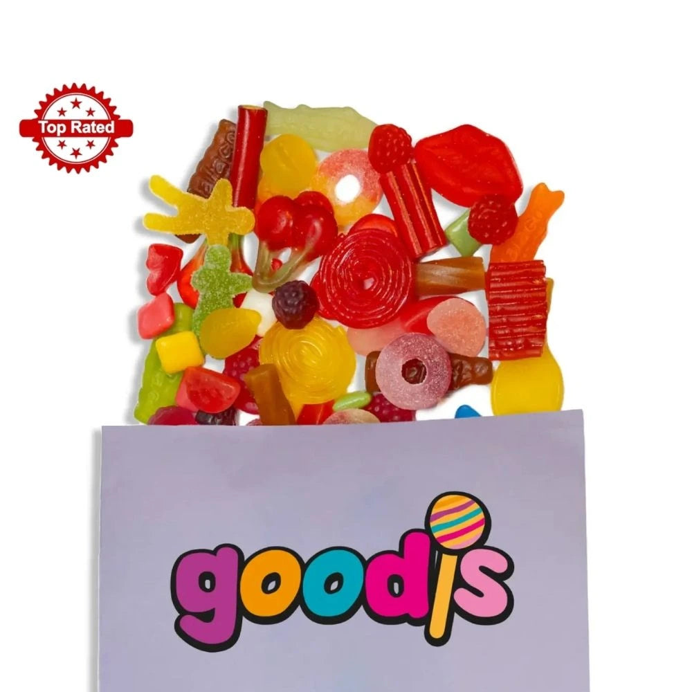 A mix of Swedish candy in different colors and shapes, such as cherries, lips and rings, popping out from a purple candy bag with the logo "Goodis" on it.