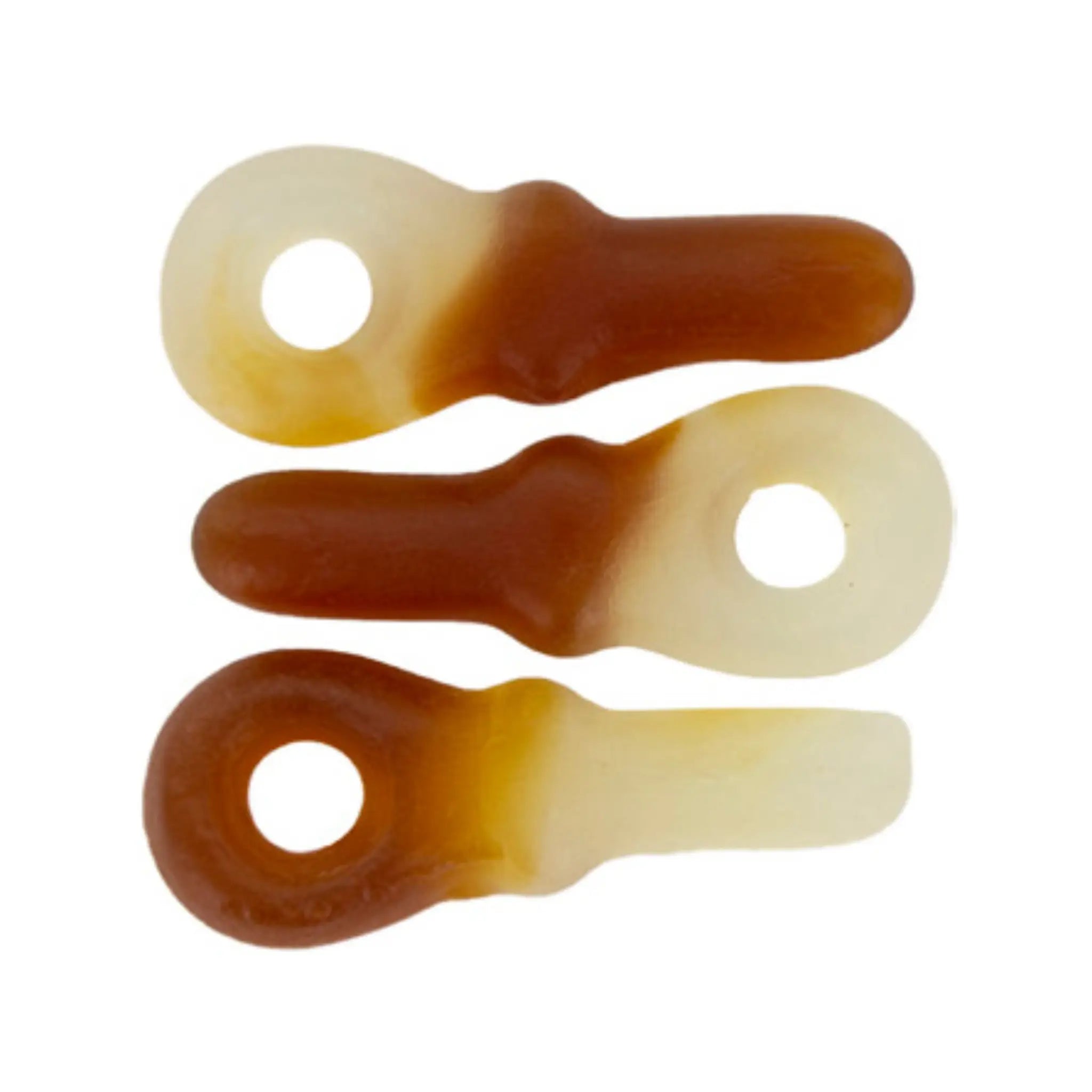 Three pieces of Swedish candy in the shape of pacifiers in brown and white.