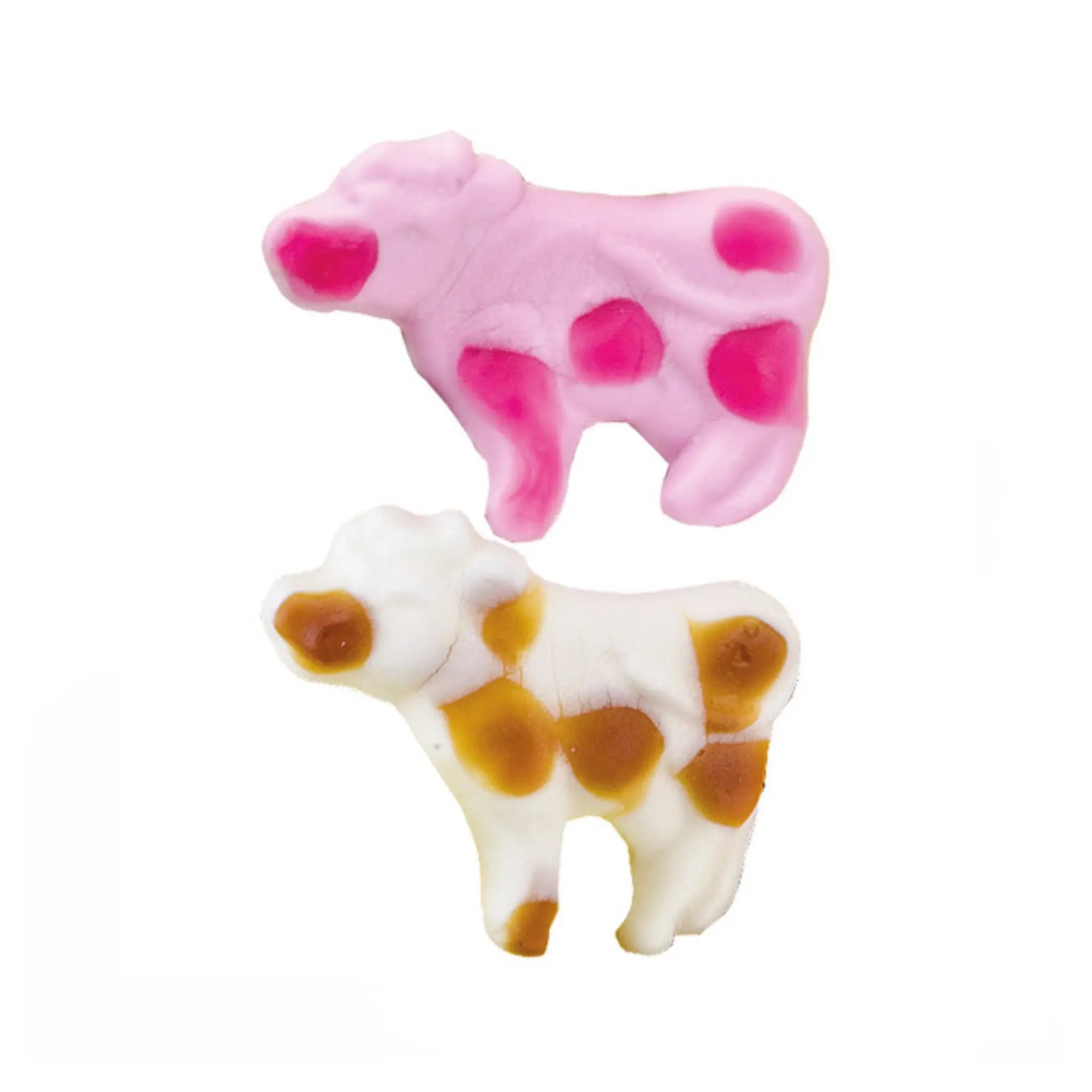 Two pieces of candy in the shape of cows, in white and brown, and pink.