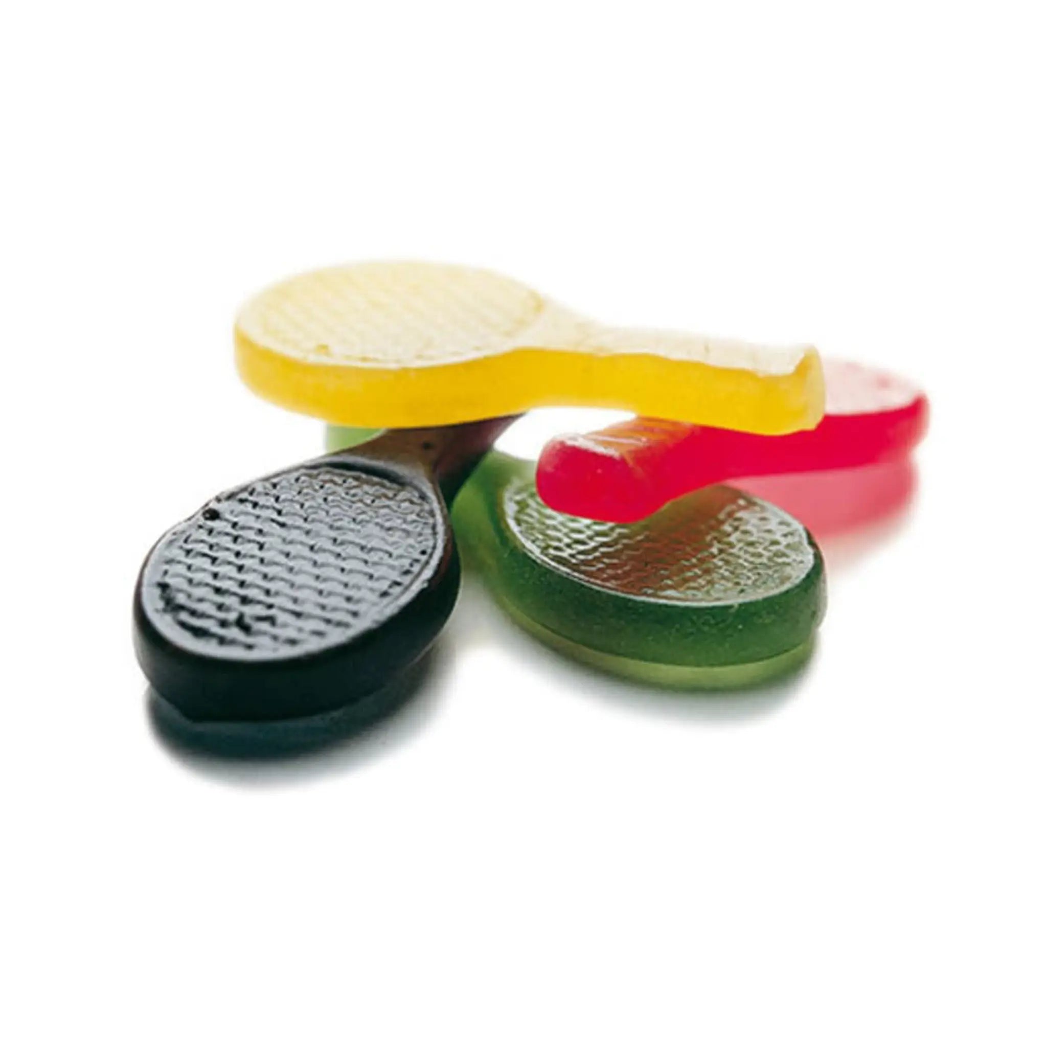 Swedish candy in the shape of four tennis rackets in black, green, red and yellow.