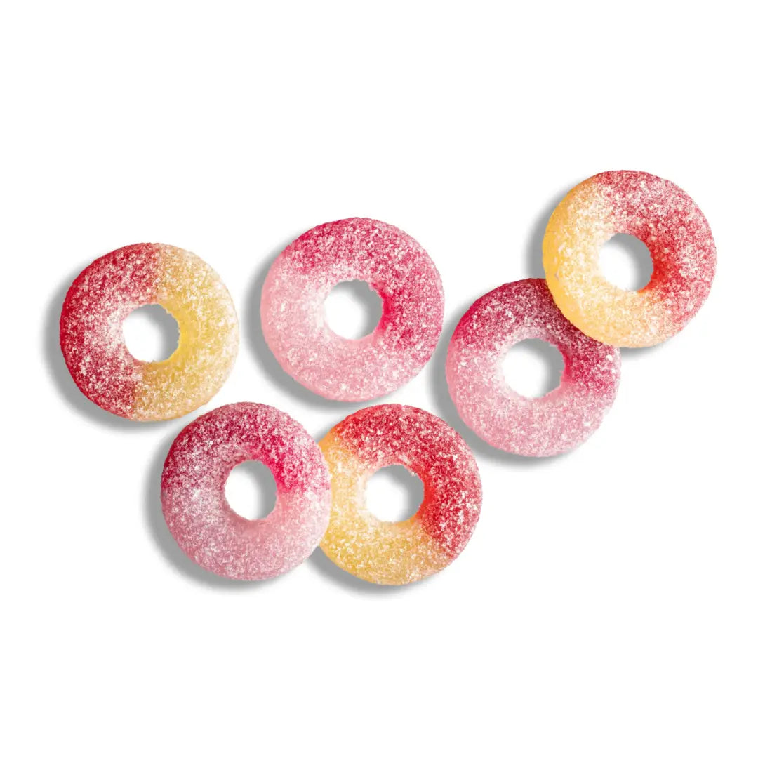 Six different pieces of candy in the shape of rings in purple, red and yellow.