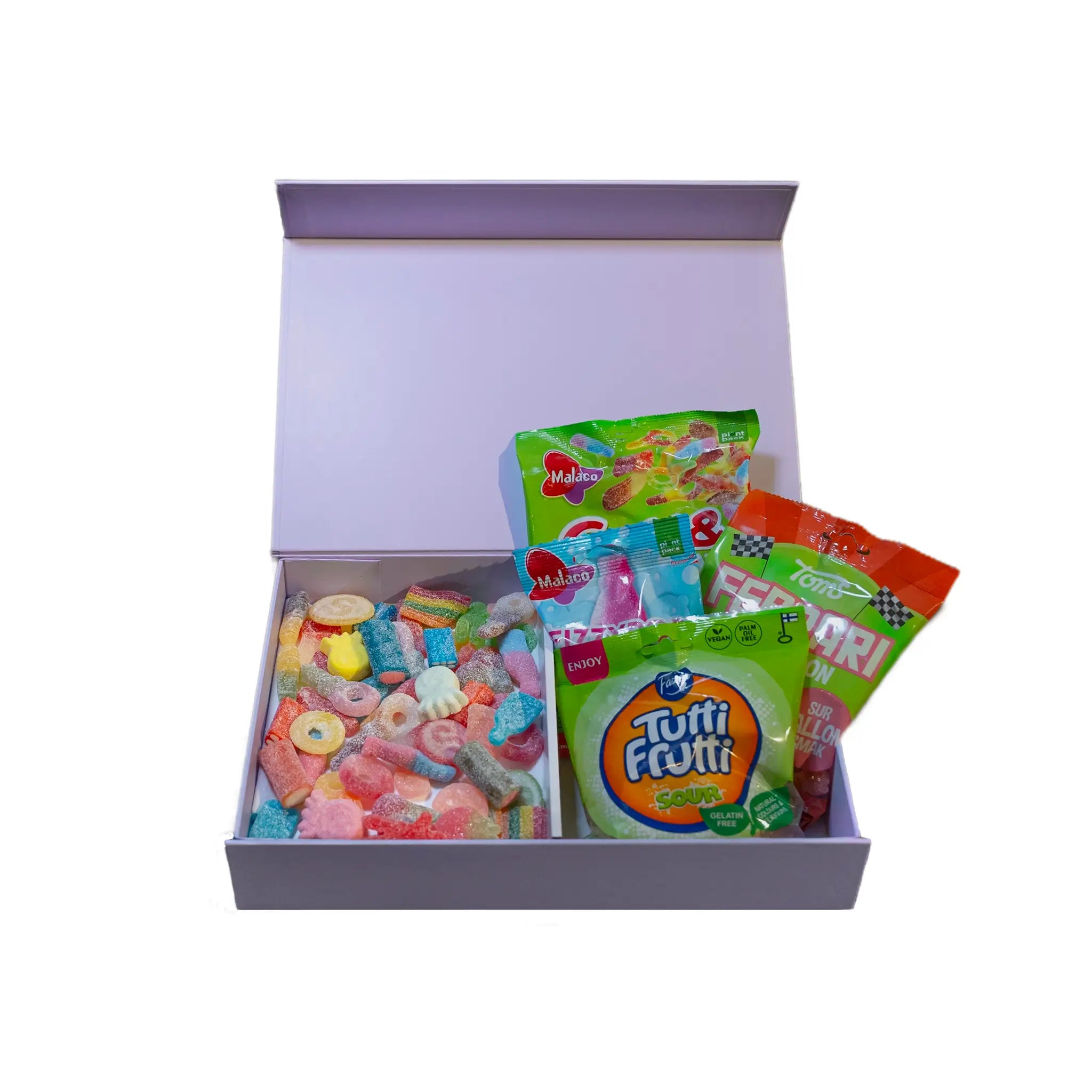 An open purple gift box filled with different kinds of candy, both pieces and bags.