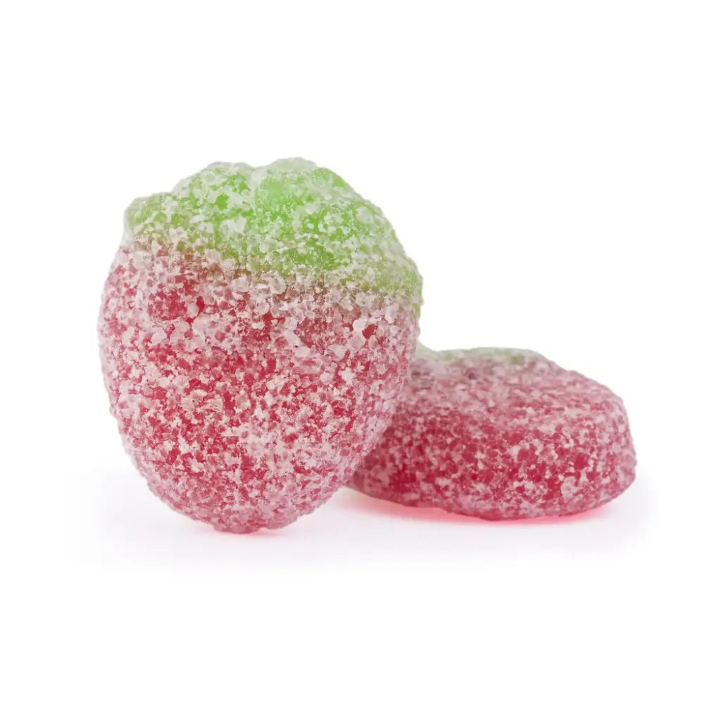 Two pieces of candy in the shape of strawberries, in red and green, coated in sugar.