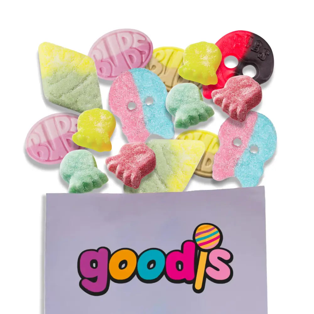 A mix of Swedish candy from Bubs in different colors and shapes, such as skulls, rhombs, ovals, and octopus, coming out of a purple bag with "Goodis" in the front.